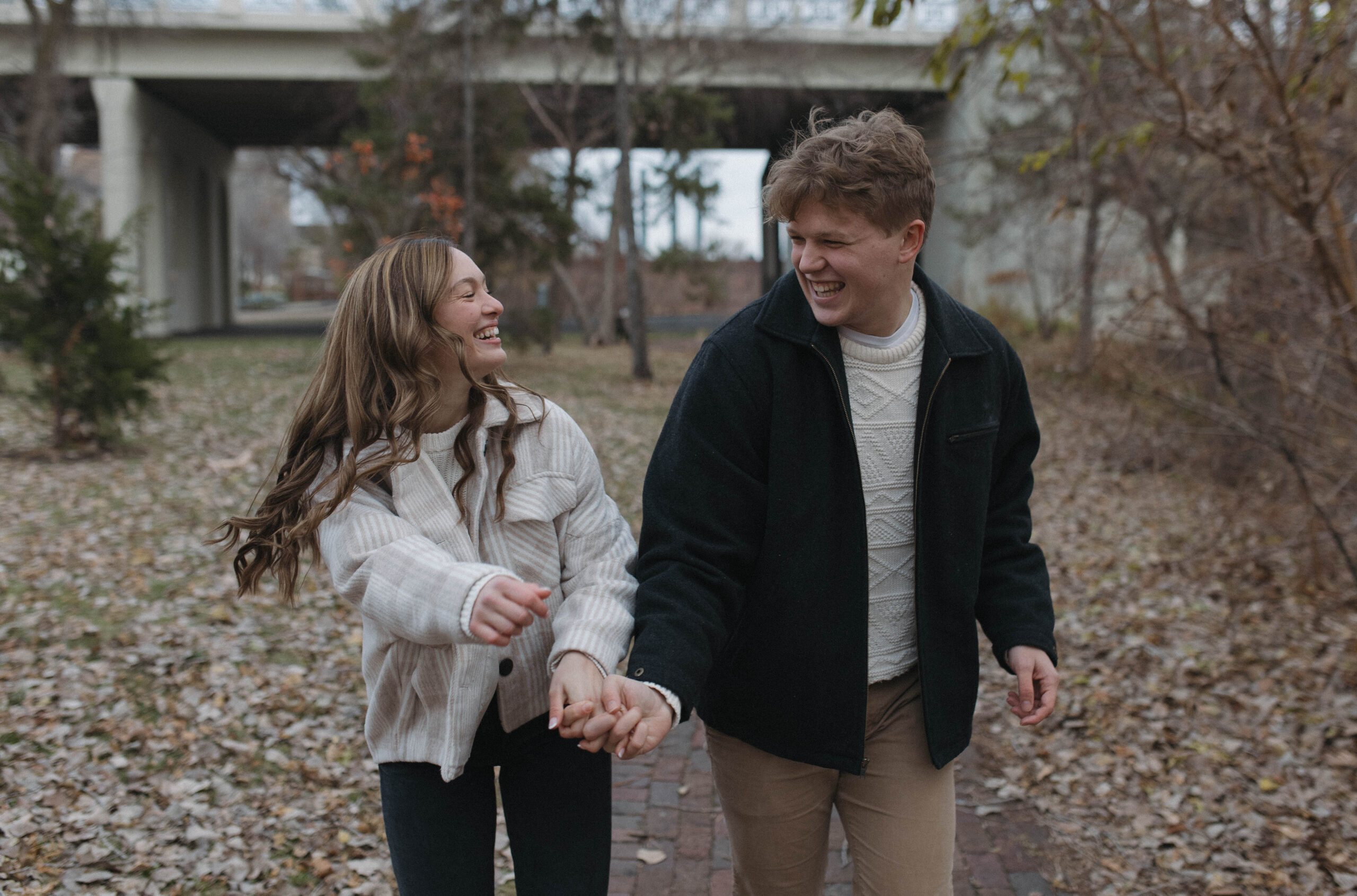 Couple smiling and walking together during their minneapolis engagement session